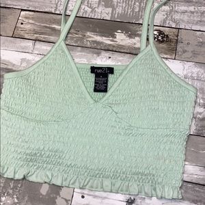very cropped light green tank top.